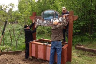 Frank Walsh, John Usher, Joe Drapeau and Earl Hodgson (not shown) repair the Villages Beautiful planter at Village Woods in Sharbot Lake.